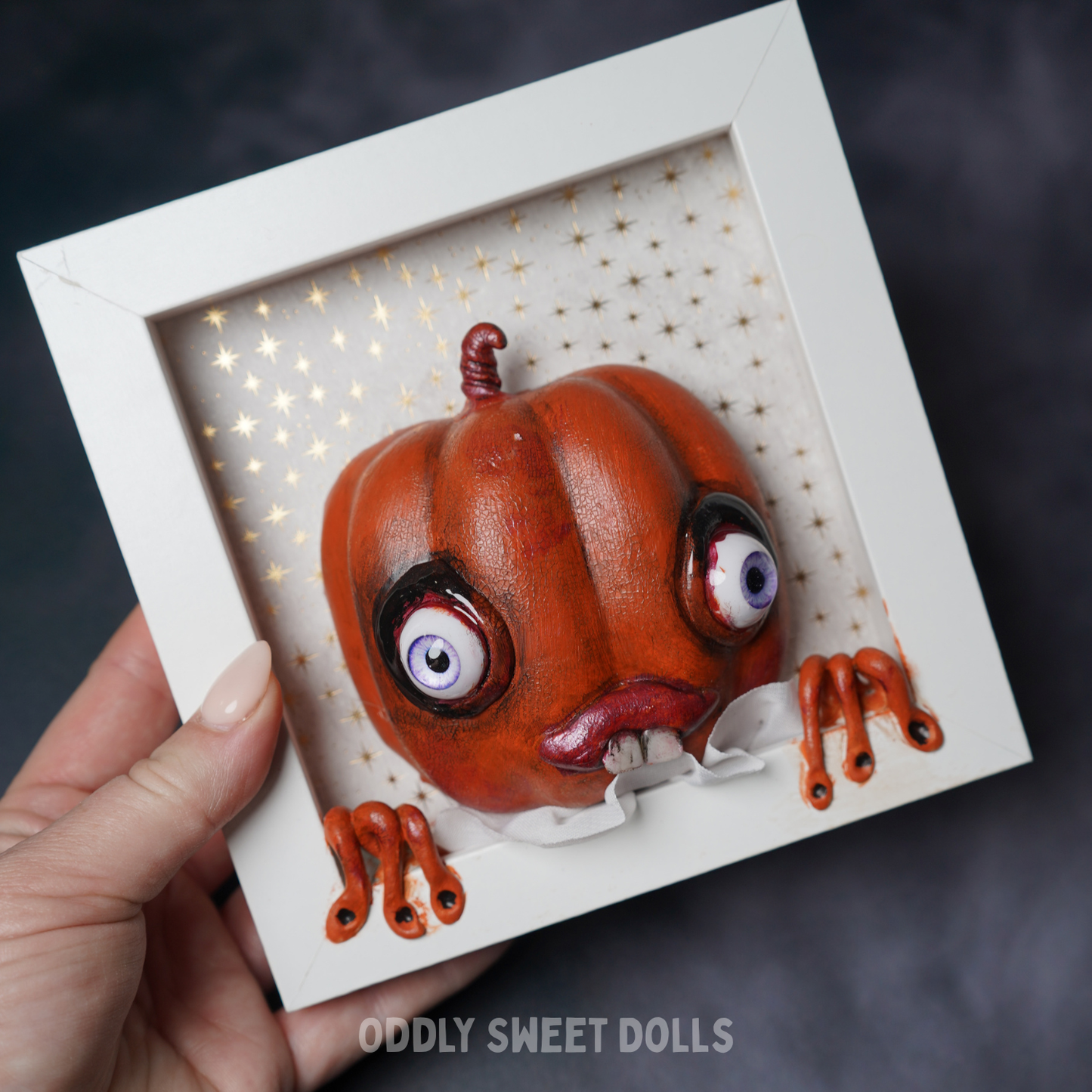 framed white frame with [umpkin big eyes and teeth