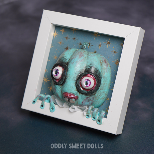 white frame pumpkin with big eyes and teeth