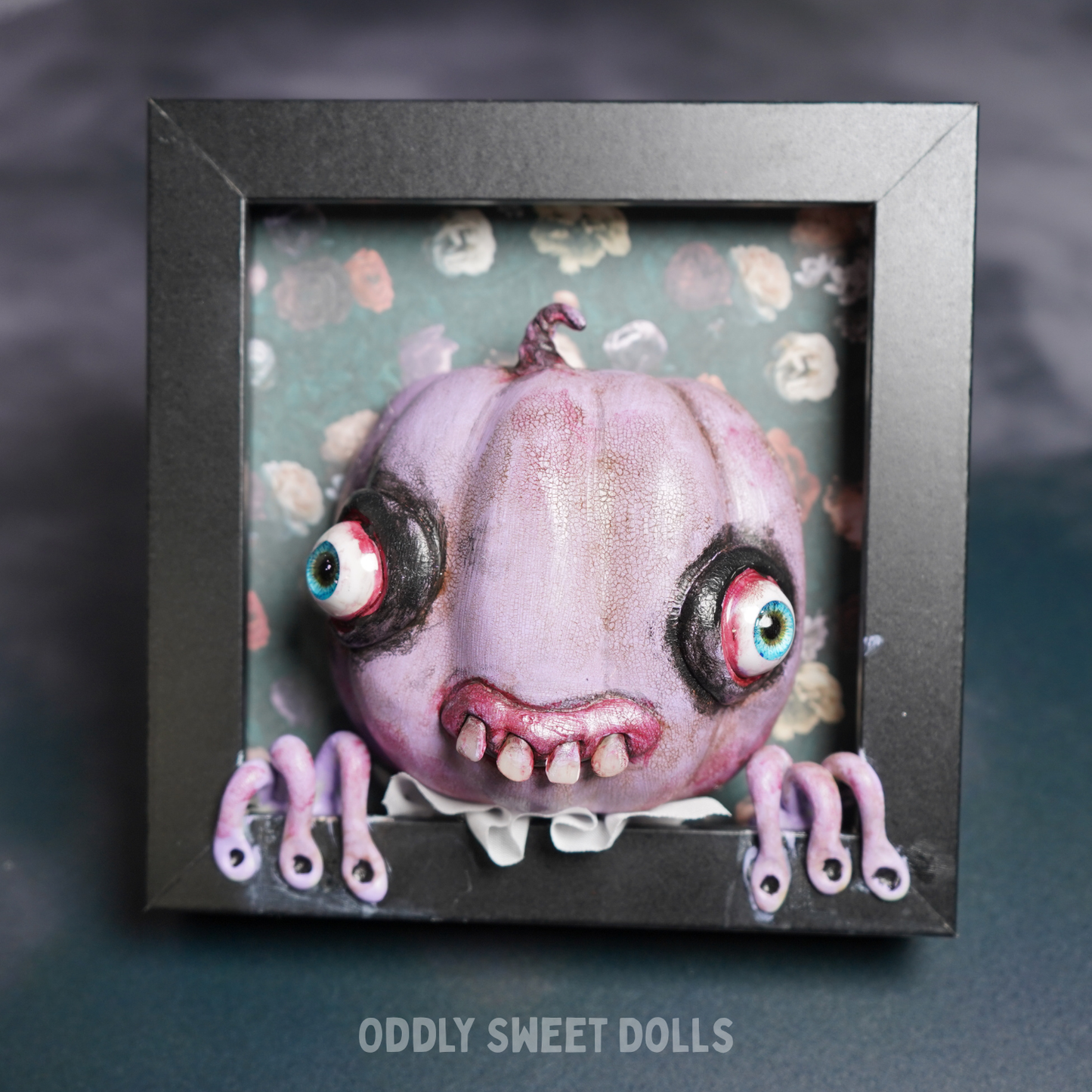 framed pumpkin with big eyes and teeth