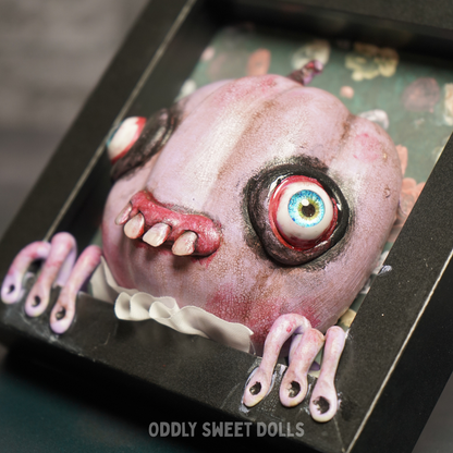 framed pumpkin with big eyes and teeth