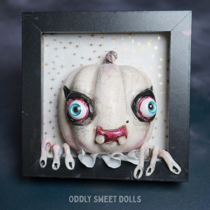 framed pumpkin with big eyes and teeth