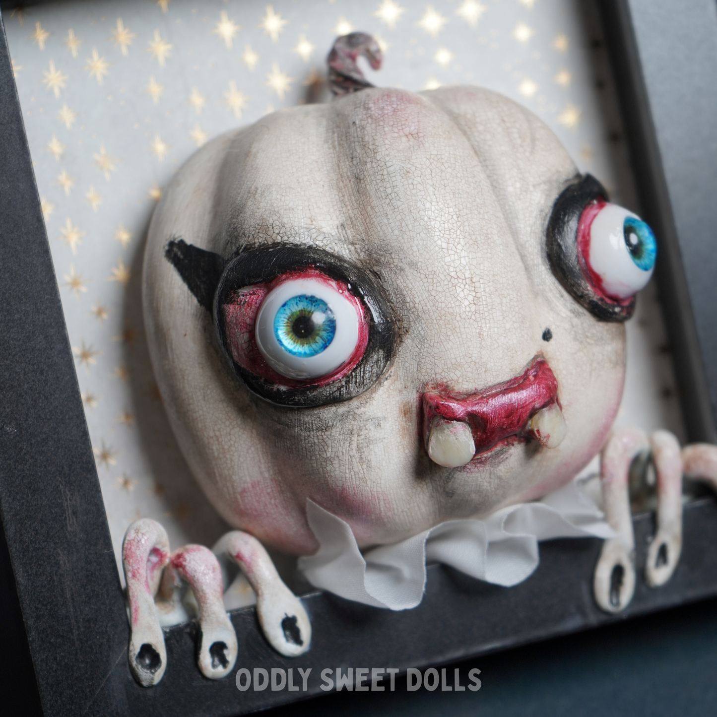 framed pumpkin with big eyes and teeth