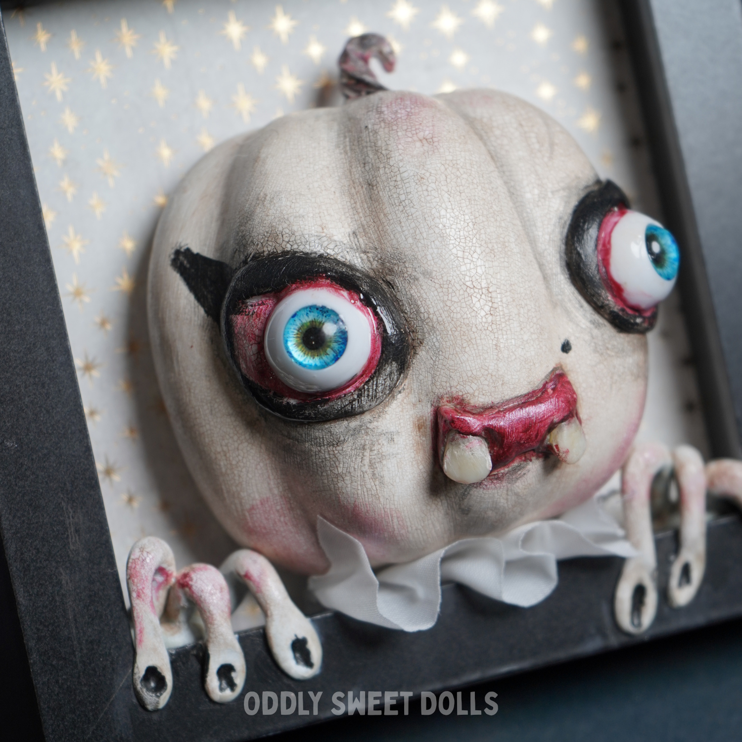 framed pumpkin with big eyes and teeth