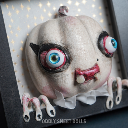framed pumpkin with big eyes and teeth