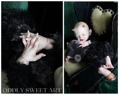 reborn baby doll fawn sitting on a black victorian rocking chair upclose details of hands