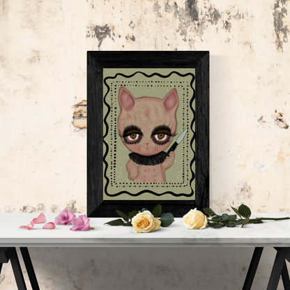 bunny holding a knife with a green background in a black frame on a table top