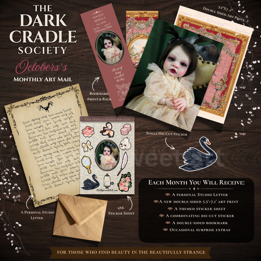 A digital graphic with a black background and ornate gold corner flourishes, featuring the text 'THE DARK CRADLE SOCIETY' at the top. Below, white and gold text lists included items for a monthly reborn doll photography subscription, including a double-sided 5x7 collectible art print, themed sticker sheet, individual sticker, coordinating sticker, bookmark, surprise sticker, and a personal letter from the studio. Each month you will receive a new piece of art, bookmark, sticker sheet, and die cut sticker. 