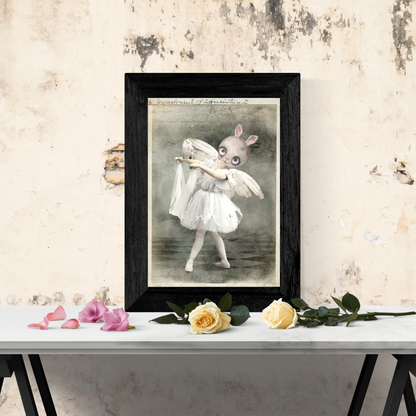 white background post card art print bunny ballerina holding a white owl framed in a black frame on table top