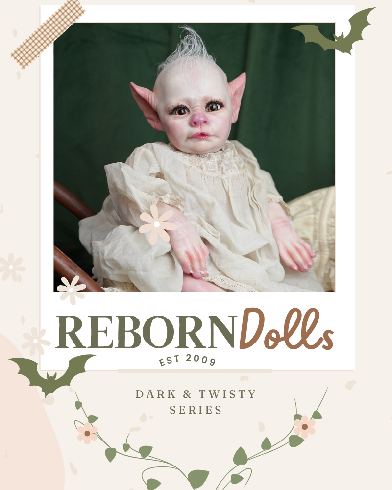 Reborn doll with white hair and pointed ears on a dark background, featuring 'Reborn Dolls' branding.