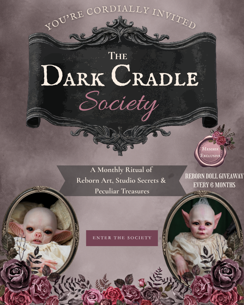 The Dark Cradle Society website banner with two reborn dolls inviting you to join the monthly membership of art, studio secrets and there is a 6 month reborn give away. 