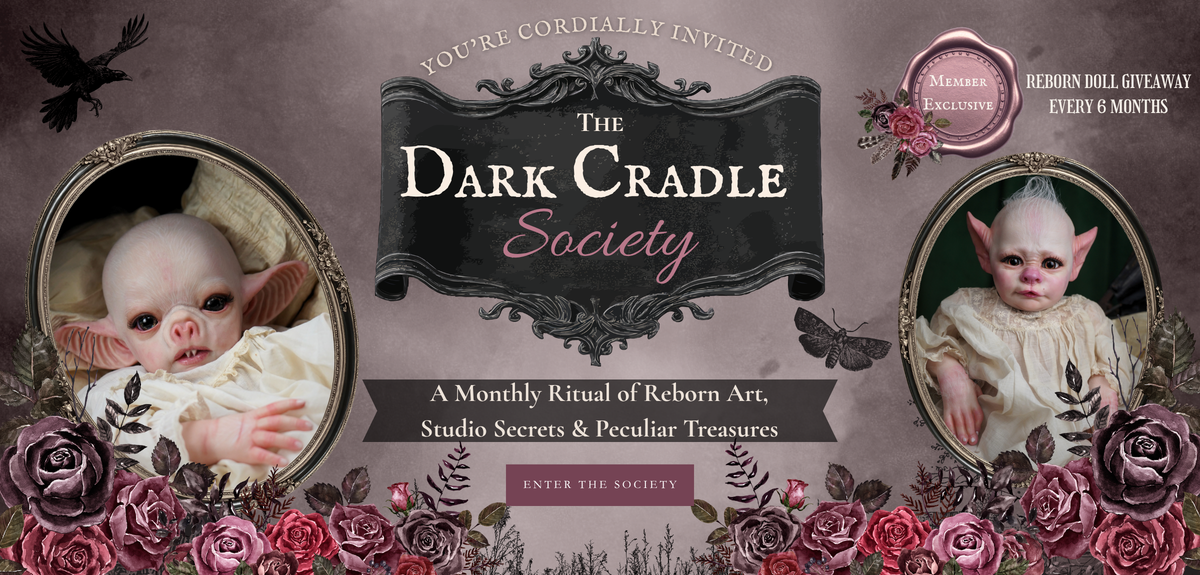 The Dark Cradle Society website banner with two reborn dolls inviting you to join the monthly membership of art, studio secrets and there is a 6 month reborn give away. 