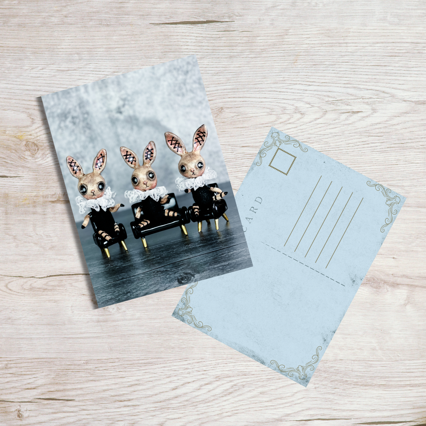 framed black and blue bunny blue postcard on light wood table